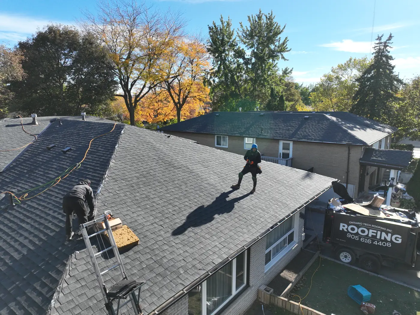 Hamilton roof at the finishing stage with the Ontario Tech Roofing disposal trailer parked in front