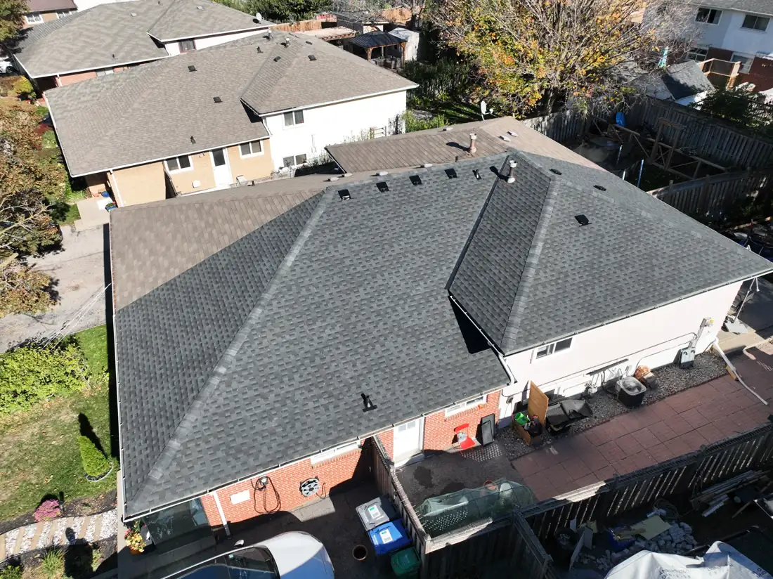 Aerial view of the completed Bonnymede Drive roof in Mississauga showing new dark grey architectural shingles, crisp hip lines and black roof vents