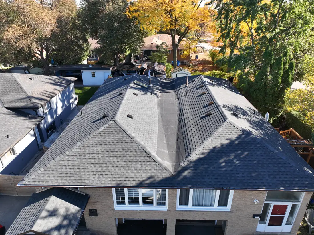 Front aerial view of the finished Bonnymede Drive roof in Mississauga, with new shingles, hip caps and roof vents